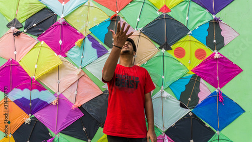 Young Man with Thread ball for makar sankranti. Makar sankranti is an Indian kite festival. It is also known as uttarayan photo