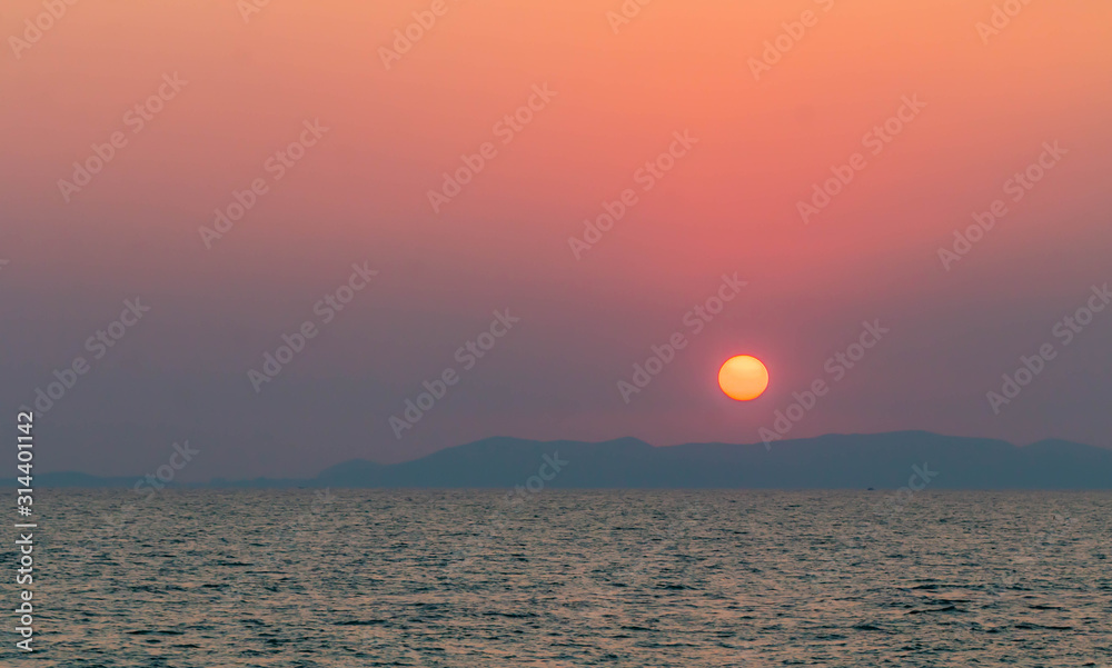 Bright sunset with large yellow sun under the sea surface Bright sunset with large yellow sun under the sea surface