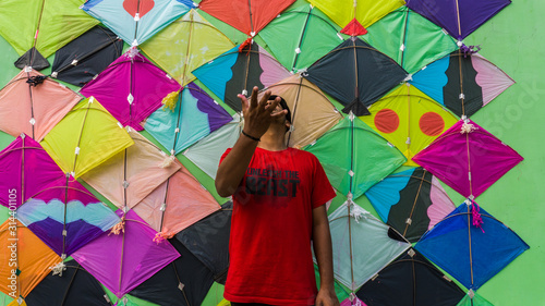 Young Man with Thread ball for makar sankranti. Makar sankranti is an Indian kite festival. It is also known as uttarayan photo