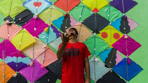 Young Man with Thread ball for makar sankranti. Makar sankranti is an Indian kite festival. It is also known as uttarayan photo