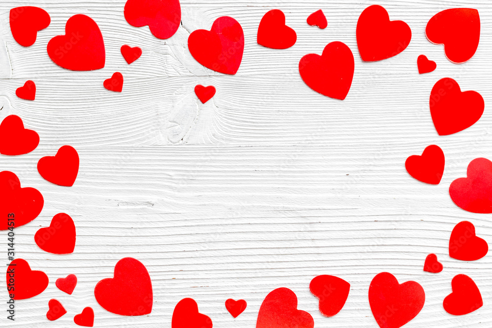 Valentine's Day design. Red hearts frame on white wooden background top-down copy space Valentine's Day design. Red hearts frame on white wooden background top-down copy space