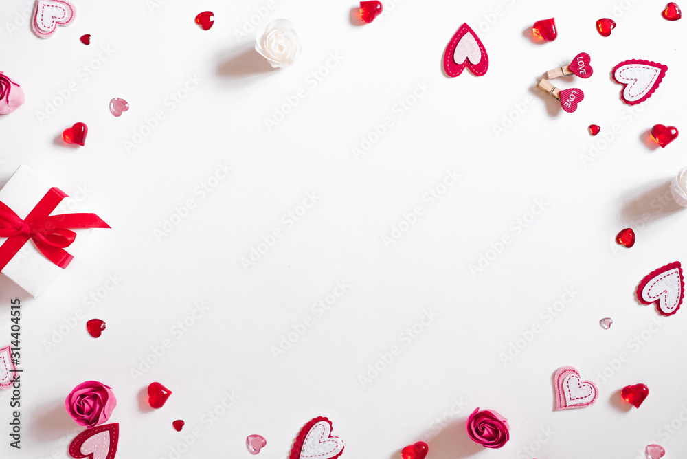 A gift frame with a red bow, beads, glass and felt hearts on a white background. A gift frame with a red bow, beads, glass and felt hearts on a white background.