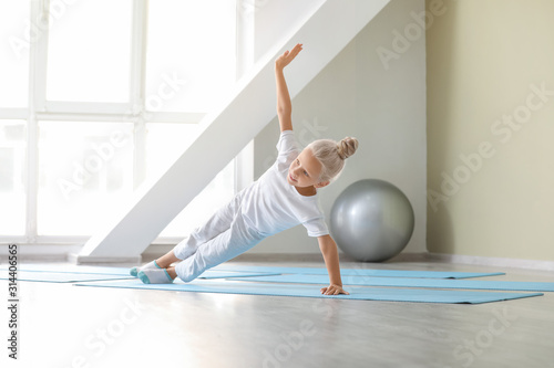 Little girl practicing yoga...