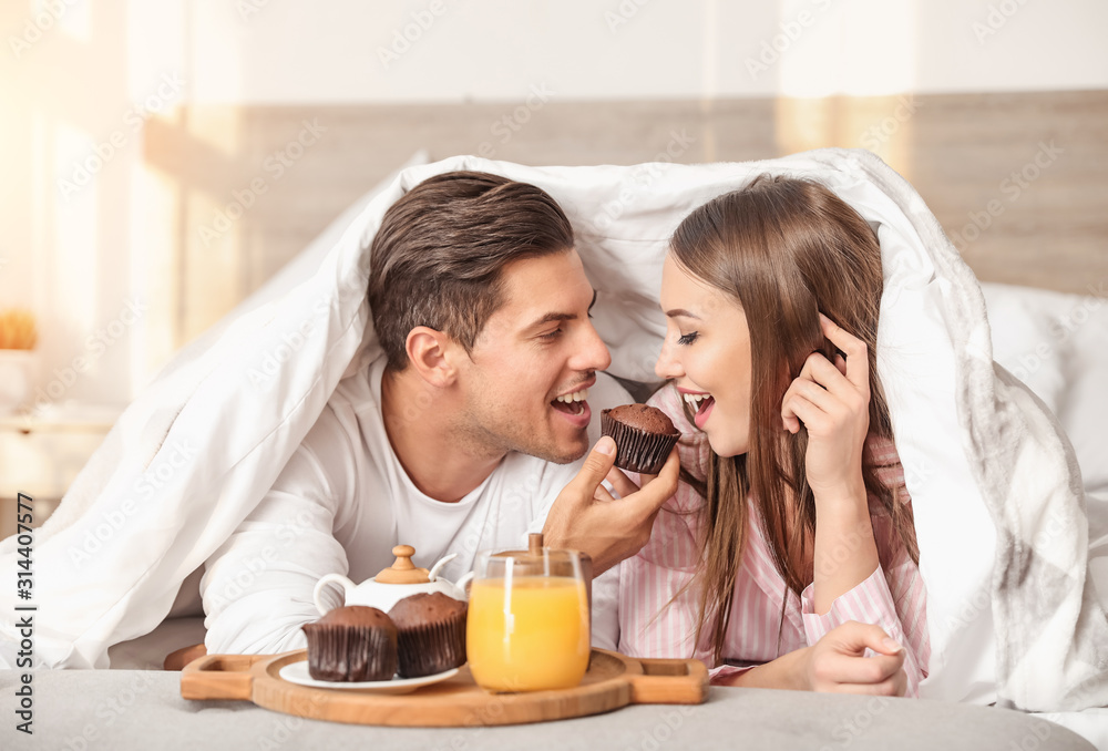 Morning of young couple having breakfast in bed Morning of young couple having breakfast in bed