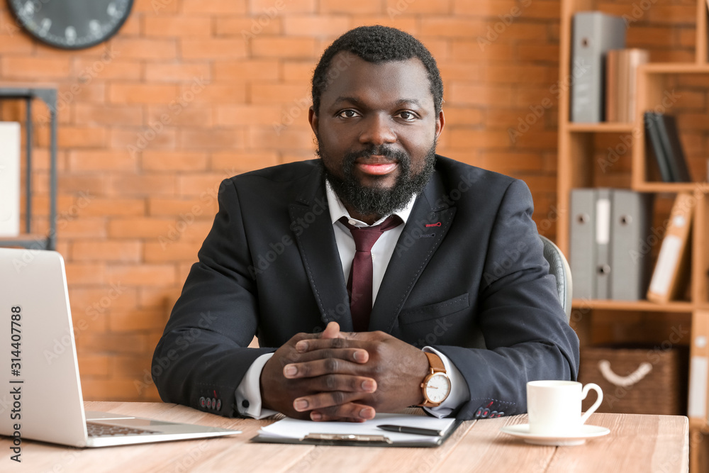 African-American lawyer at table in office African-American lawyer at table in office