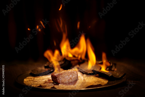 wagyu beef in burning bamboo charcoal photo