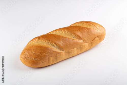 loaf of bread "rifled" on white background. Freshly Baked Homemade Bread, close-up on a stone table