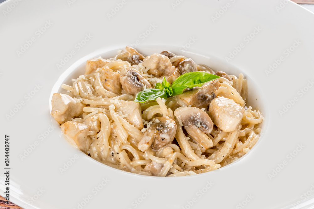 Creamy pasta with mushrooms in a white plate