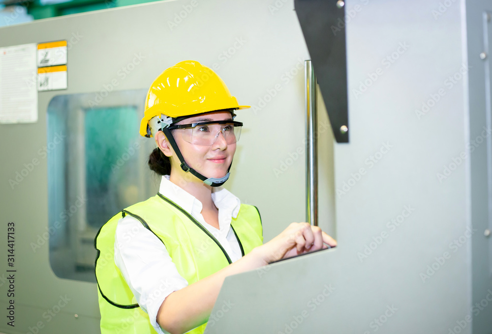 Asian woman engineer or business women are controlling machines in industrial plants. Asian woman engineer or business women are controlling machines in industrial plants.