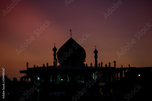 silhouette of mosque in Pattani on orange sunset background.concept for texture background.symbol and place for prey for islamic people