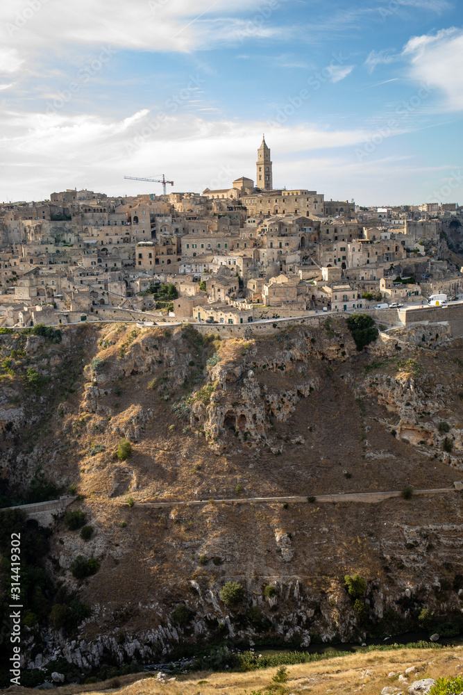 Panoramic view of Sassi di Matera a historic district in the city of Matera, well-known for their ancient cave dwellings from the Belvedere di Murgia Timone,  Basilicata, Italy