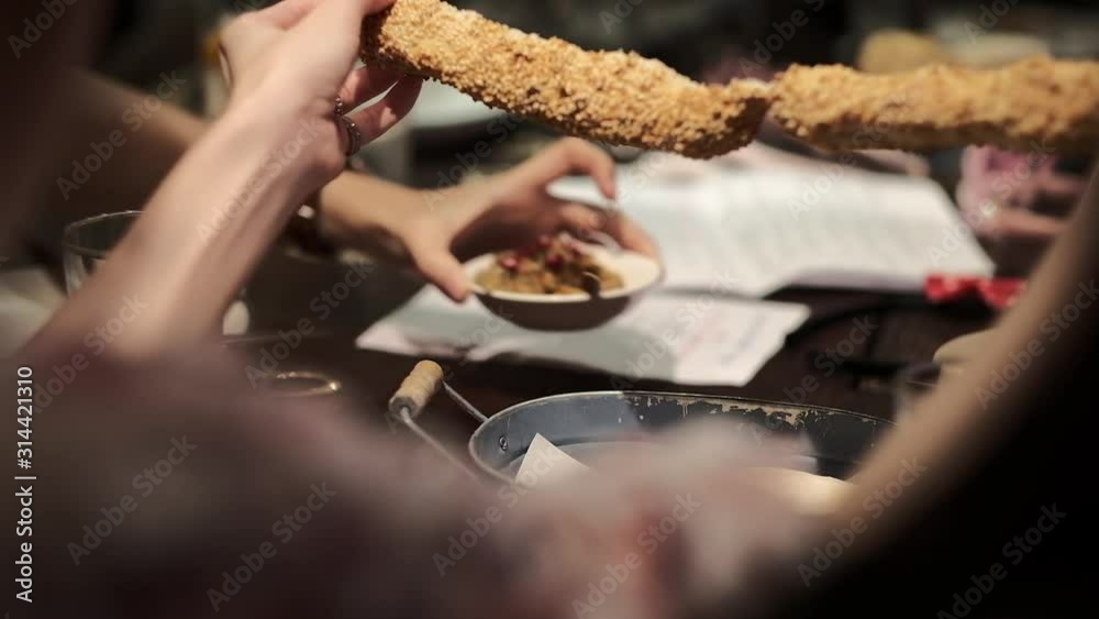 People having dinner at table and Shred bread. eating dinner and leisure concept People having dinner at table and Shred bread. eating dinner and leisure concept
