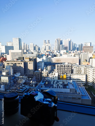 blurred camera with Shinjuku skyscraper skyline building top view in the morning. Japan city urbanscape real estate.
