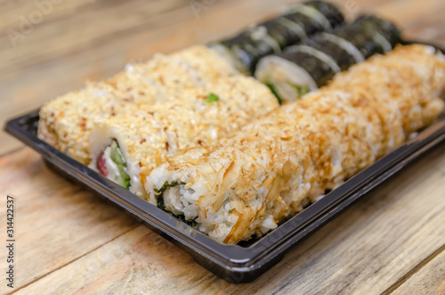 Set sushi Toto Maki, Bonito Maki, Akito Maki on a wooden background. Top view, side view photo