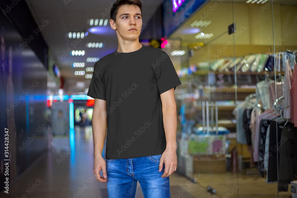 Mockup of a black male t-shirt on a young guy, front view. Mockup of a black male t-shirt on a young guy, front view.