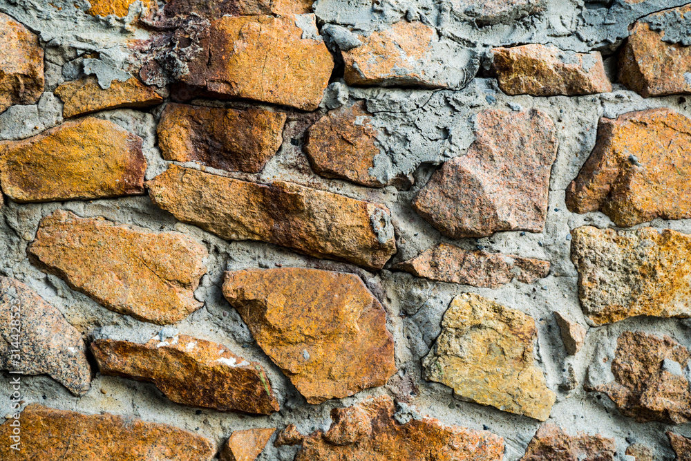 The texture of the old masonry. Background image of a stone-lined wall The texture of the old masonry. Background image of a stone-lined wall