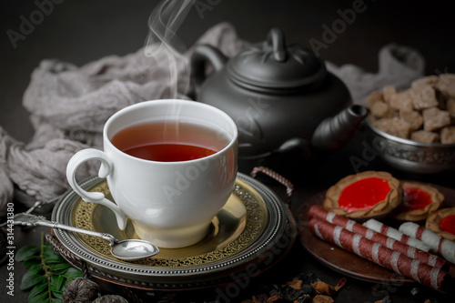 Tea hot drink on old background in composition on the table