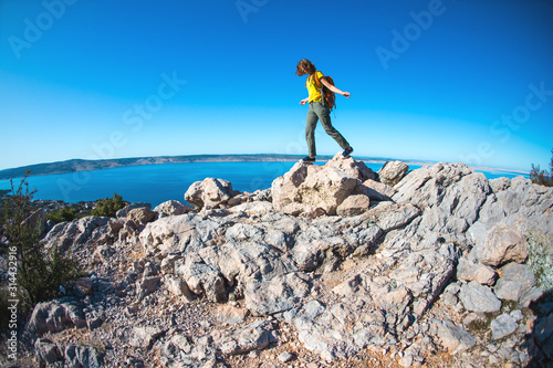 Girl on the background of the sea and mountains.