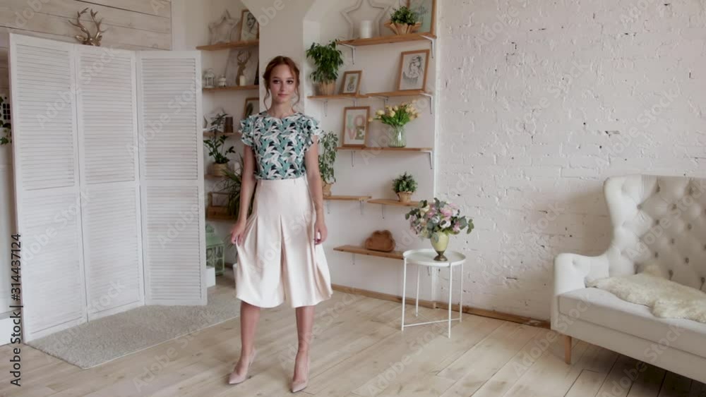 Young girl walking around the room in a dress in a beautiful interior, in the house, slow motion Young girl walking around the room in a dress in a beautiful interior, in the house, slow motion