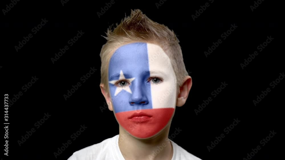 Sad fan of the football team of Chili.. A child with a face painted in national colors. Unhappy boy with sad eyes. Fiasco of your favorite team. Disappointment. Sadness. Experience. Failure. Bad luck. Sad fan of the football team of Chili.. A child with a face painted in national colors. Unhappy boy with sad eyes. Fiasco of your favorite team. Disappointment. Sadness. Experience. Failure. Bad luck.