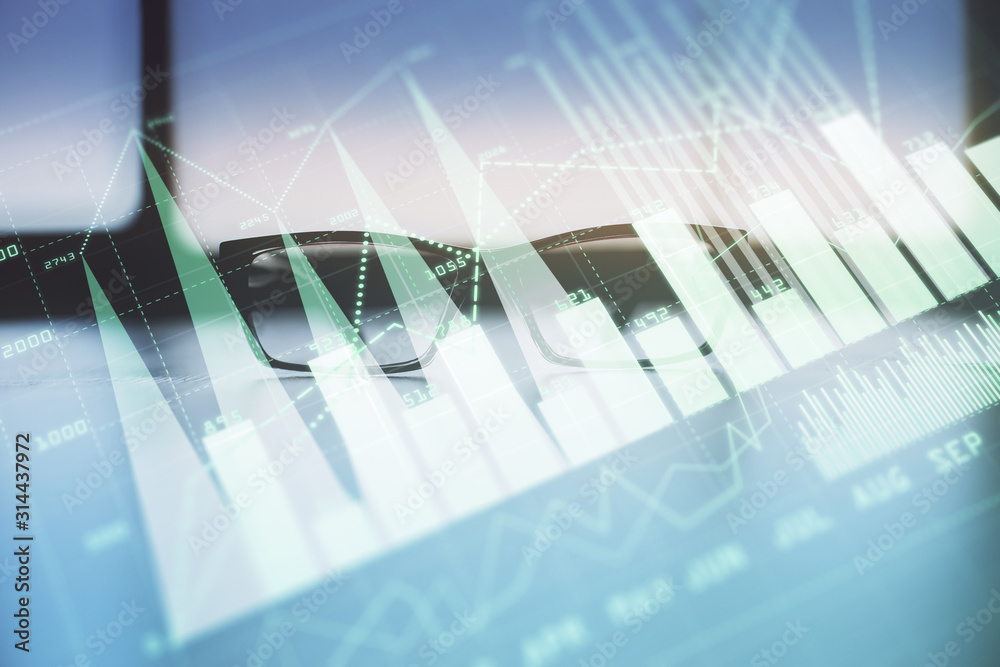 Financial graph hologram with glasses on the table background. Concept of business. Double exposure.