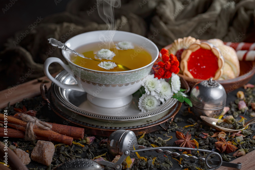 Hot tea in a cup on an old background. Hot tea in a cup on an old background.