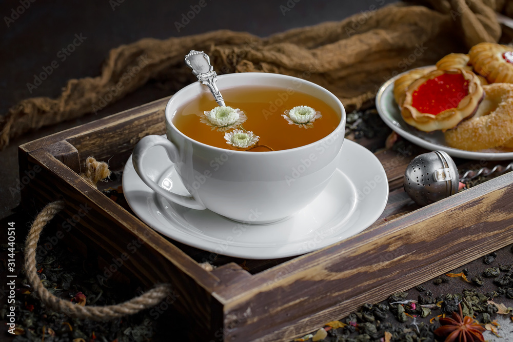 Hot tea in a cup with kitchen accessories Hot tea in a cup with kitchen accessories