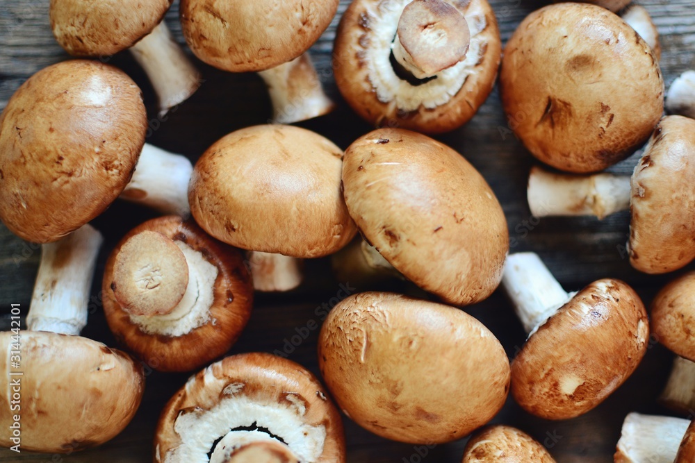 Royal fresh mushrooms on a wooden background. Whole brown mushrooms Royal fresh mushrooms on a wooden background. Whole brown mushrooms