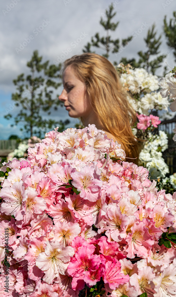young woman among the flowers of azalea young woman among the flowers of azalea