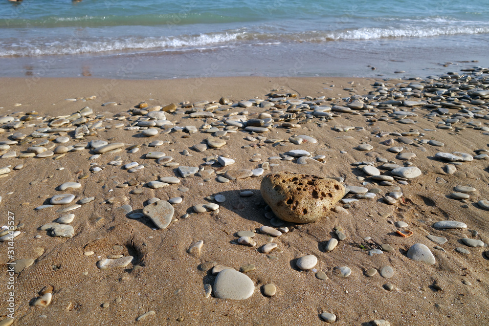 Small stones sand and sea wave. Small stones sand and sea wave.