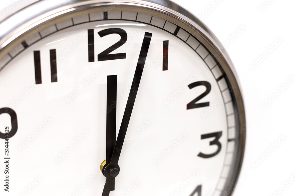 Classic circle clock with clock hands showing twelve hours. Time management, procrastination, productivity concept. Close up photo. Classic circle clock with clock hands showing twelve hours. Time management, procrastination, productivity concept. Close up photo.