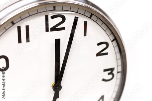 Classic circle clock with clock hands showing twelve hours. Time management, procrastination, productivity concept. Close up photo.