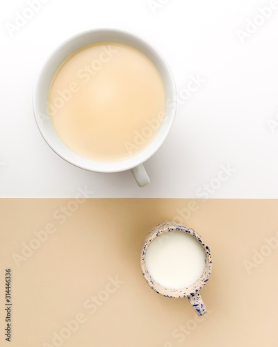 Coffee and milk on white beige bacground on a concept picture
