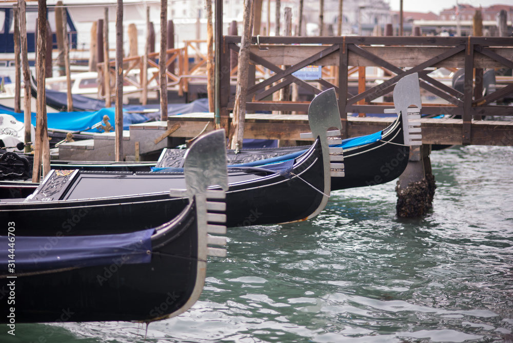 Venice, Italy - March 1, 2019: Gondolas docked at the pier of San Marco square.