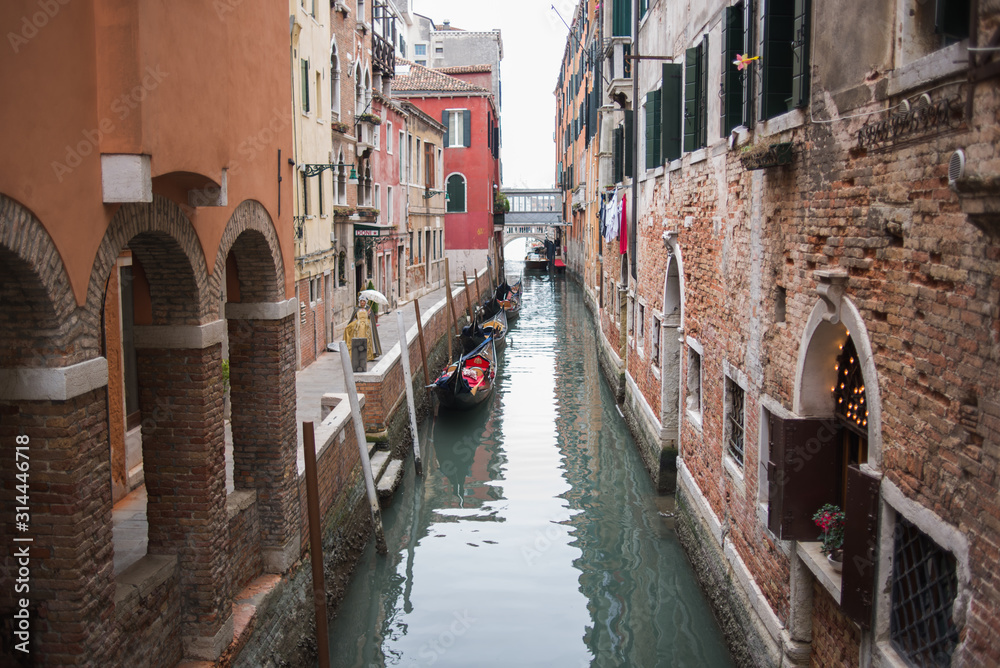 Venice, Italy - March 1, 2019: Gondolas on a canal in the streets of Venice.