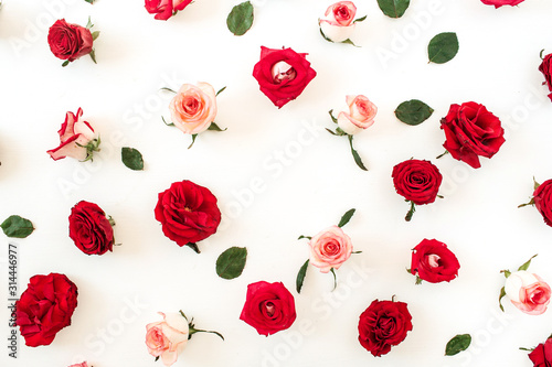 Fototapeta Naklejka Na Ścianę i Meble -  Round frame border of pink, red rose flower buds and leaves on white background. Mockup blank copy space. Flat lay, top view floral composition.