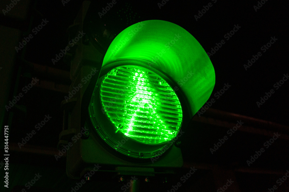 Green traffic light sign close up. Adjustment of vehicles with LED lamps. Green traffic light sign close up. Adjustment of vehicles with LED lamps.