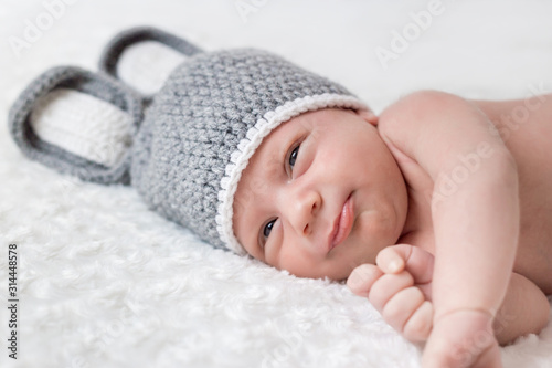 Cute little baby lies in a hare costume on a white background. newborn in a hat with ears on a white background © Olena