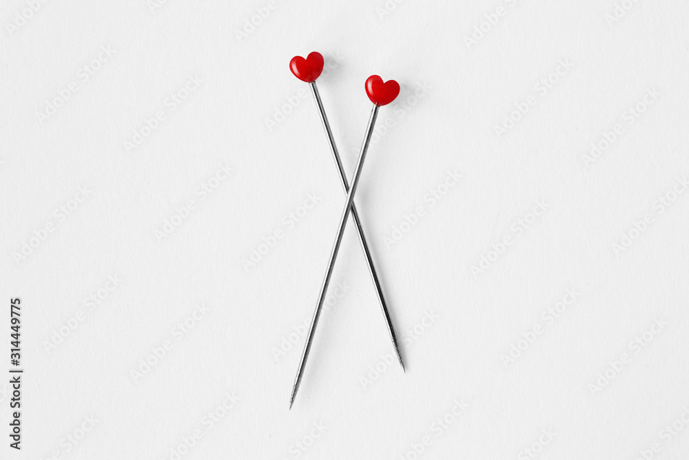 Two heart shaped pins on white background - Concept of love and relationship Two heart shaped pins on white background - Concept of love and relationship