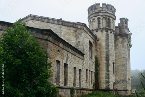 Old ruined abandoned castle in rainy autumn day photo