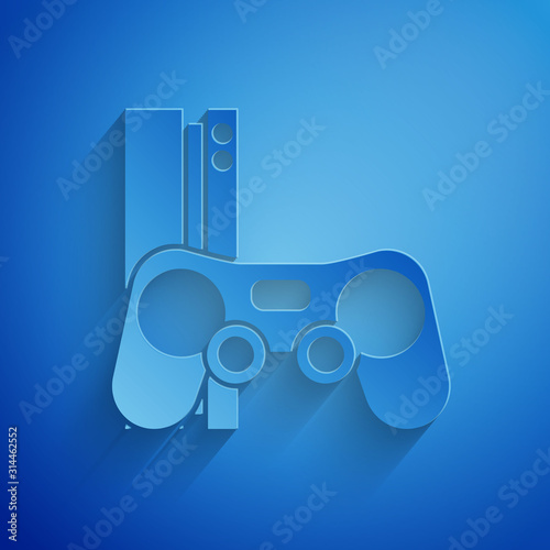 Paper cut Video game console with joystick icon isolated on blue background. Paper art style. Vector Illustration