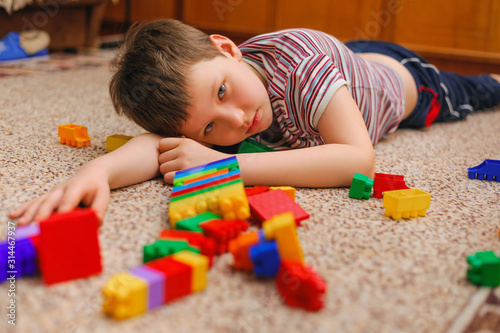 sad kid near the fallen tower from the constructor