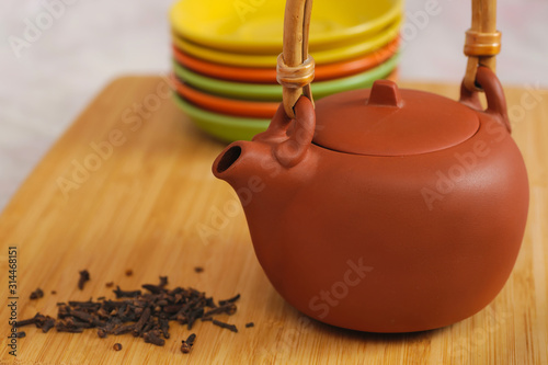 clay teapot on color plates backgrounds photo