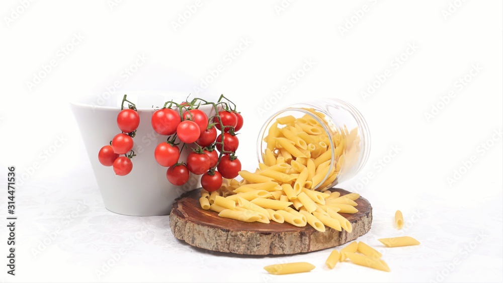 close-up of pasta and cherry tomatoes on a white background close-up of pasta and cherry tomatoes on a white background
