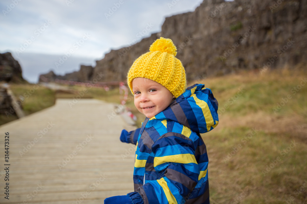 Child, boy, enjoying a sunny day in Thingvellir National Park rift valley, Iceland Child, boy, enjoying a sunny day in Thingvellir National Park rift valley, Iceland