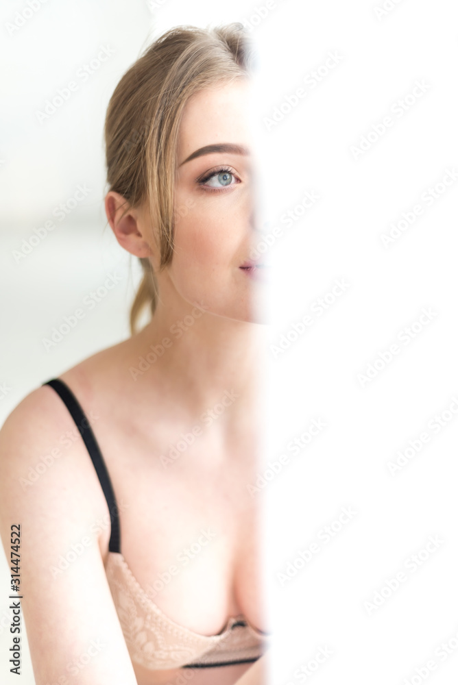Portrait of sensual woman wearing underwear near window Portrait of sensual woman wearing underwear near window