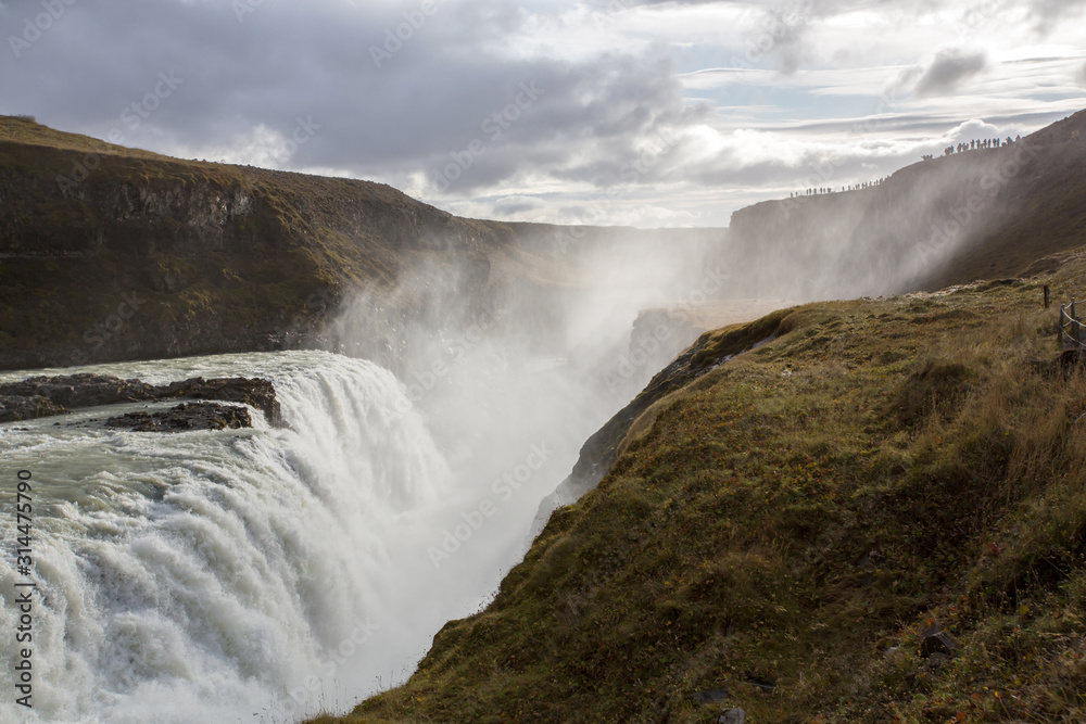 Landscape with big majestic Gullfoss waterfall in mountains in Iceland Landscape with big majestic Gullfoss waterfall in mountains in Iceland