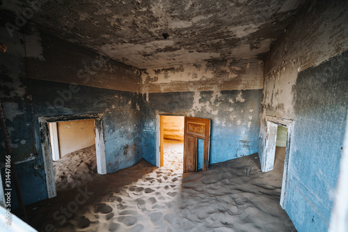 Sand Dune filling up abandoned Ghost Town House through doors and broken window © wideeyes