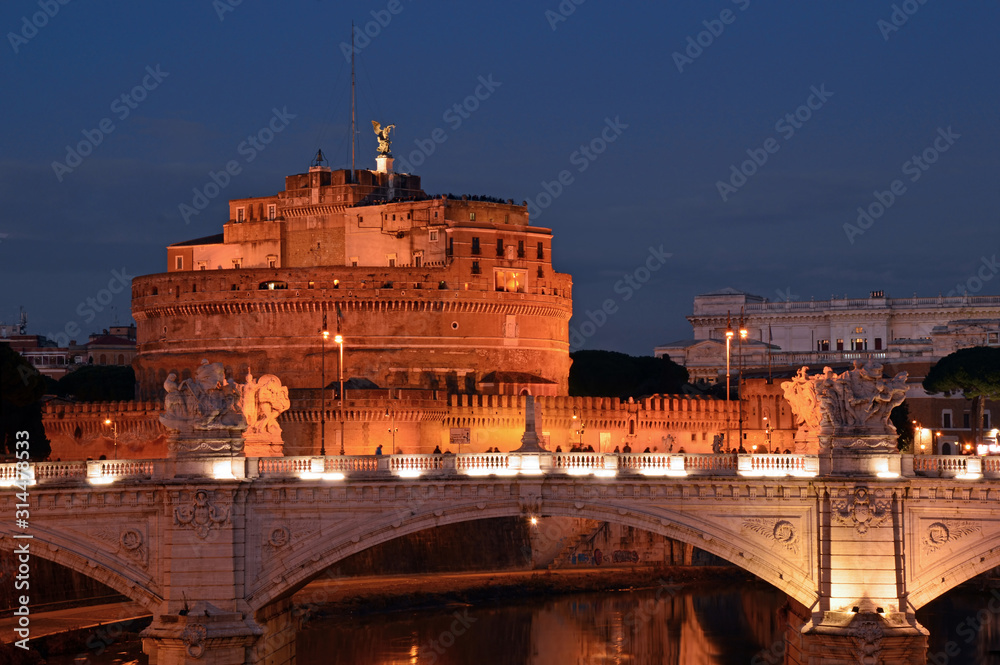 A night view of Castel Sant'Angelo and the Tiber river in Rome - Italy