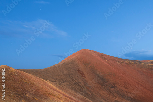 Beautiful red volcanic mountains and blue sky. Panoramic landscape.